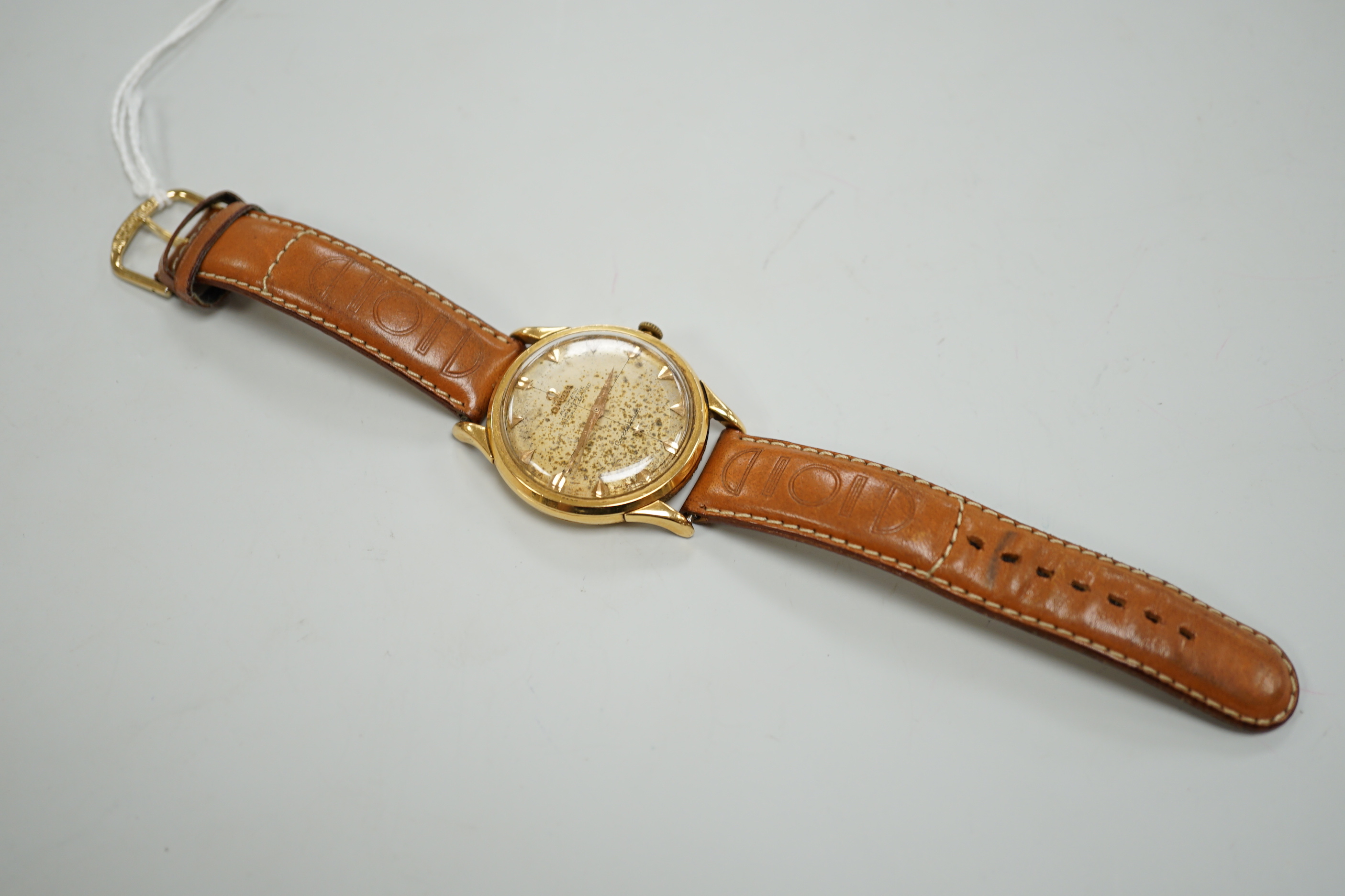 A gentleman's 1950's yellow metal (French 18ct poincon mark) Omega Constellation automatic wrist watch, on associated strap, case diameter 35mm, dial a.f.